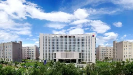 Pharmaron's Beijing site features a modern, multi-story office building with a curved façade, set against a clear sky.