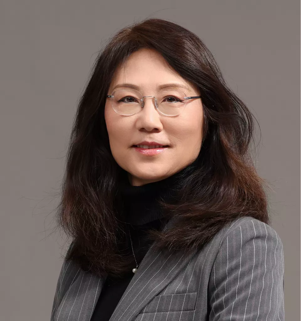 Connie Sun, Ph.D. - A professional woman with shoulder-length dark hair and glasses smiles softly. She is wearing a gray pinstripe blazer over a black top, perhaps ready to discuss radiolabelled ADME studies. The background is a plain, neutral gray.