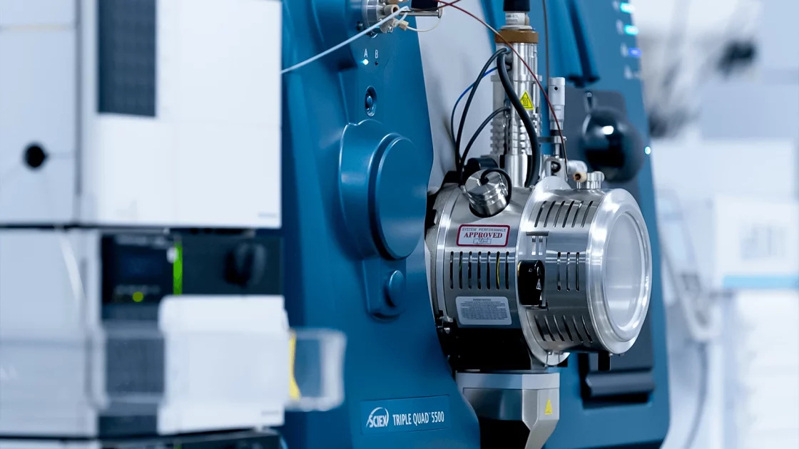 Close-up of a SCIEX Triple Quad 5500 mass spectrometer used for pharmacokinetic/pharmacodynamic (PK/PD) analysis in a laboratory setting.