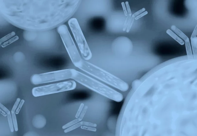 Illustration of antibodies floating in a blue, blurred background, representing immunogenicity assays and their role in detecting immune responses.