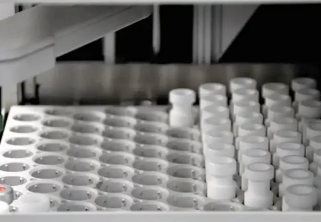 An automated laboratory instrument loaded with multiple sample vials for metabolite profiling with radiolabeled compounds in the lab.