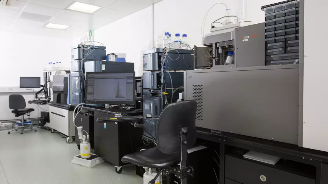 A laboratory setup featuring advanced analytical instruments and computers for biopharmaceutical product characterization and quality control analytics.