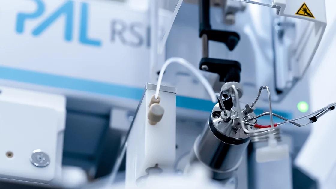 Close-up of an automated liquid handling system used in regulatory DMPK studies, featuring precision tubing and analytical components for sample preparation.