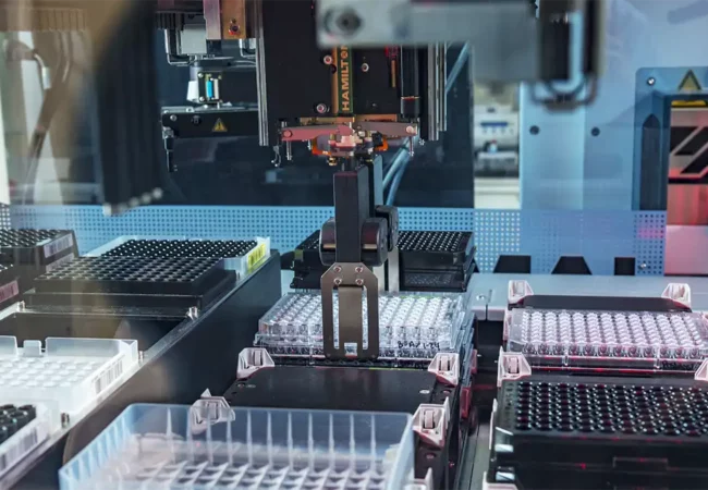 Automated robotic system handling 96-well plates in a high-throughput setup for regulatory in vitro ADMET screening assays.