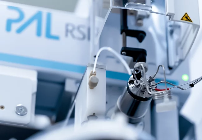 Close-up of advanced analytical equipment, likely used for small molecule bioanalysis. The intricate tubing and precision components suggest high-sensitivity testing, critical for detecting and quantifying small biological compounds.