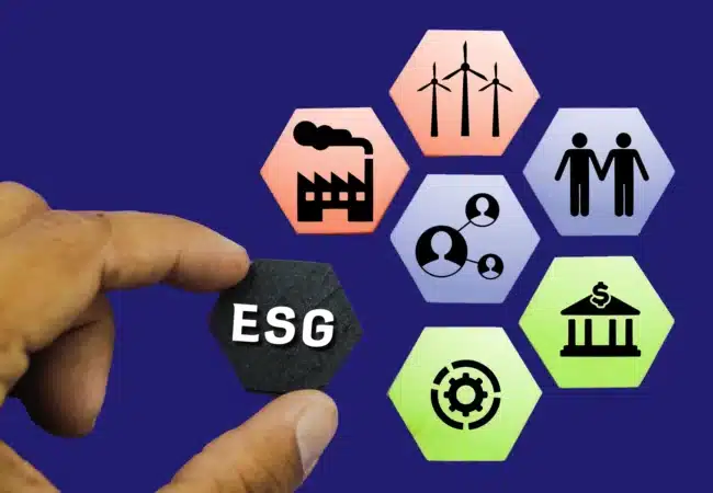 A hand holds an ESG block, surrounded by hexagons representing key elements of Environmental, Social, and Governance practices. Icons depict clean energy, industry, relationships, and financial growth, emphasizing the integration of ESG principles into responsible and sustainable business operations
