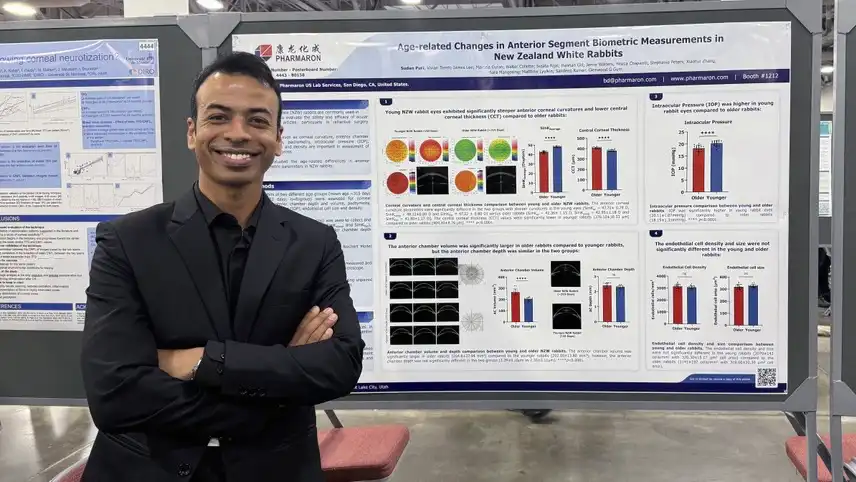 Scientist stands before Pharmaron poster on ocular buffer tolerability for cell and gene therapies, featuring eye imaging and toxicity data.