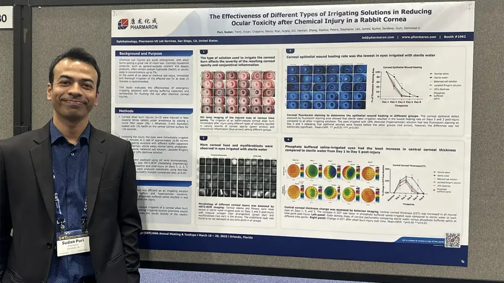 Scientist presenting Pharmaron research at SOT 2025 on ocular toxicity reduction using irrigating solutions in a rabbit cornea chemical injury model.