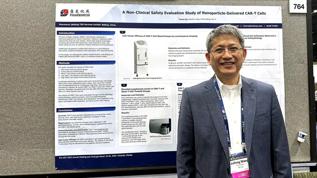 Scientist standing in front of a Pharmaron poster at SOT 2025 presenting nanoparticle-delivered CAR-T cell toxicology and safety evaluation results.