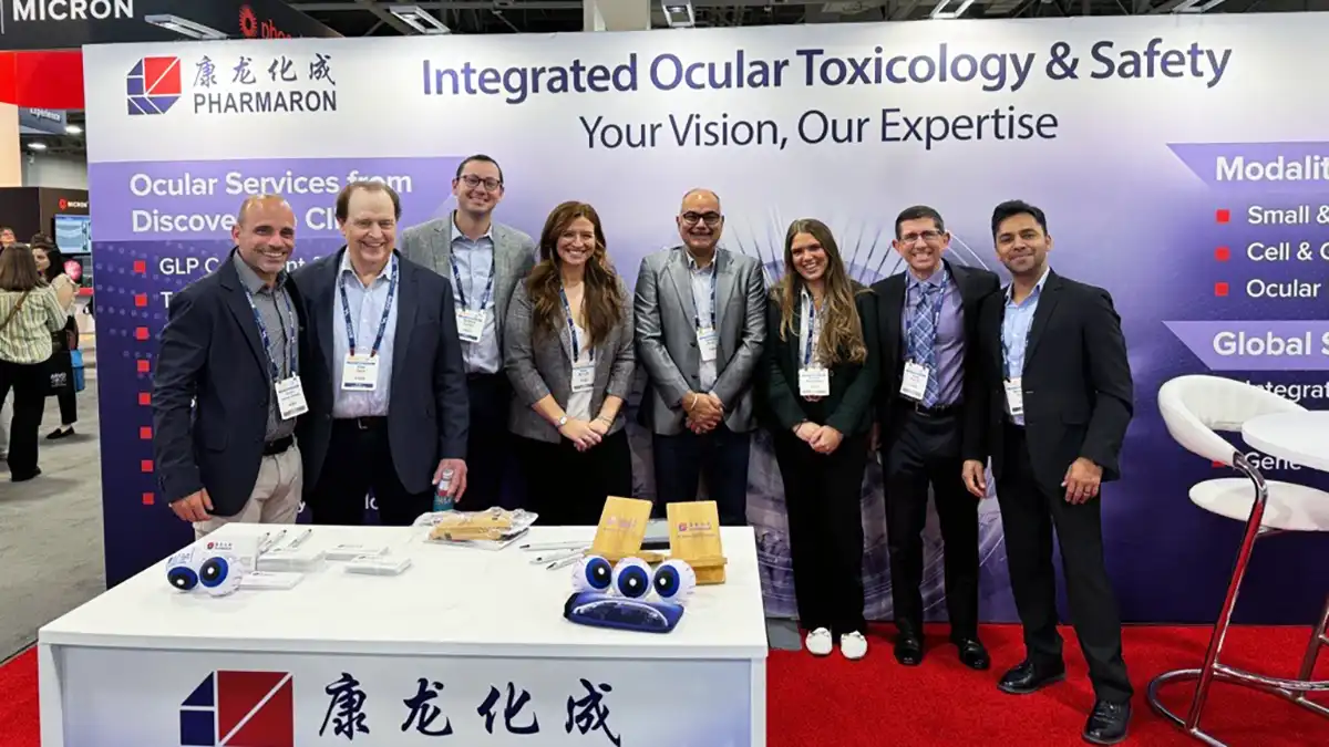A team of scientists and experts at Pharmaron’s ARVO 2025 booth promoting integrated ocular toxicology and safety services in a professional conference setting.