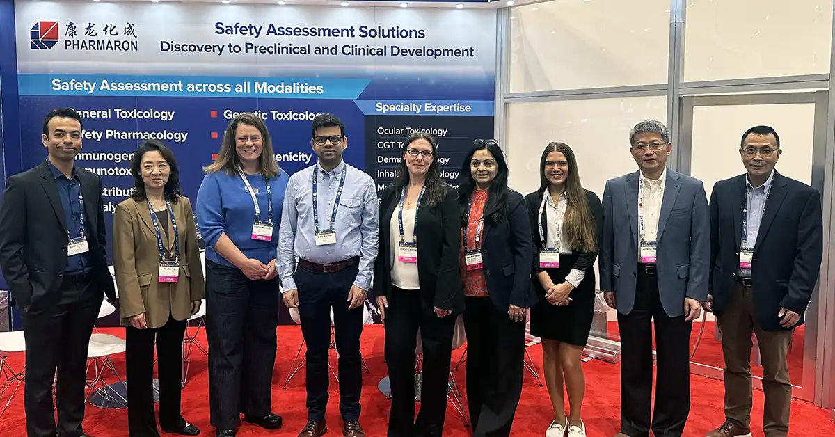 The Pharmaron team engaging at the SOT 2025 conference exhibit hall, showcasing toxicology and safety innovations with branded displays and scientific posters.