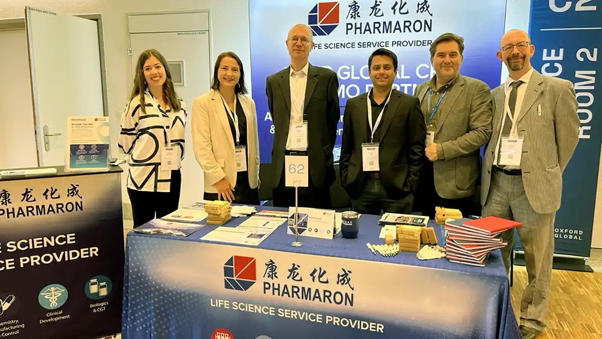 The Pharmaron team stand at Pharmaron’s booth at Discovery & Development Europe 2025, featuring branded materials and clinical service displays.