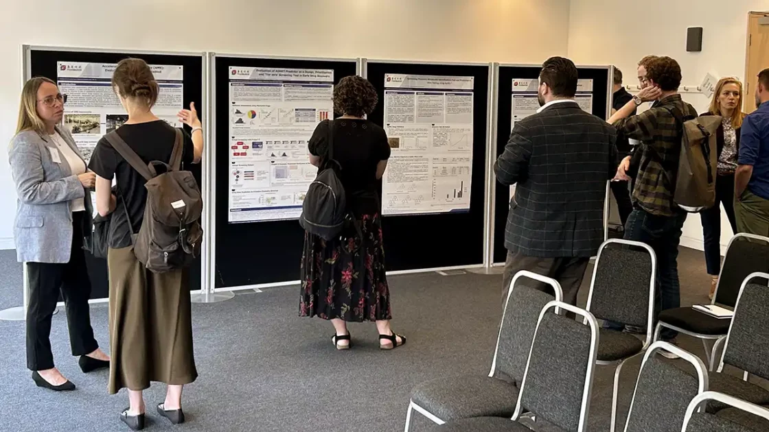 Scientists and attendees discuss ADME optimisation research posters during a drug discovery event hosted by Pharmaron.